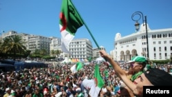 Demonstrators chant slogans during a protest demanding the removal of the ruling elite in Algiers, Algeria, July 19, 2019.
