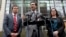Attorney General Bob Ferguson, center, stands with Solicitor General Noah Purcell, left, and Civil Rights Unit Chief Colleen Melody as he speaks with media members on the steps of the federal courthouse after an immigration hearing there, March 15, 2017, 