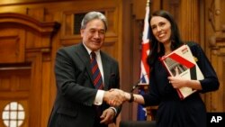 New Zealand First leader Winston Peters, left, and Prime Minister-designate Jacinda Ardern shake hands after signing a coalition agreement in Wellington, Oct. 24, 2017.