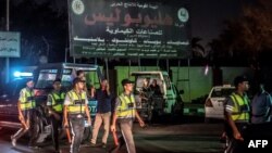 Egyptian policemen stand guard outside Heliopolis petrochemical company after a strong explosion in a chemical tank near the Cairo airport, July 12, 2018.
