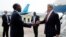 U.S. Secretary of State John Kerry (R) shakes hands with Democratic Republic of Congo Foreign Minister Raymond Tshibanda upon his arrival at N'djili Airport in Kinshasa, May 3, 2014. 