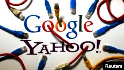 An illustration shows the logos of Google and Yahoo connected with LAN cables in a Berlin office Oct. 31, 2013. The U.S. National Security Agency has tapped into communications links used by Google and Yahoo to move huge amounts of email and other user in