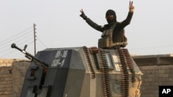 A member of Iraq's elite forces flashes a victory sign as forces advance toward Islamic State positions in the village of Tob Zawa, near Mosul, Iraq, Oct. 25, 2016.