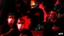 IRAN -- Iranian Shi'ite Muslims keep social distancing as they attend a mourning ritual to commemorate martyrdom of Prophet Mohammad's grandson Imam Hussein during the Islamic month of Muharram, at the shrine of Saleh in Tehran, August 27, 2020.