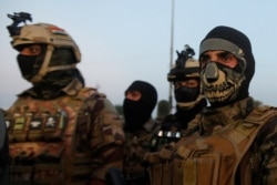 Members of the Iraqi security forces are seen during anti-government protests in Basra, Iraq, Nov. 9, 2019.