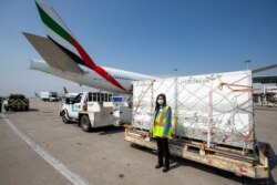 Canada's Procurement minister Anita Anand poses for a photo in front of a shipment from South Africa of the Johnson & Johnson vaccine against the coronavirus disease (COVID-19) at Toronto Pearson Airport in Ontario, Canada, April 28, 2021.