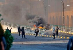 Security forces try to disperse anti-government protesters during clashes in Najaf, Iraq, Nov. 28, 2019.
