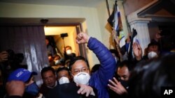 Luis Arce, presidential candidate for the Movement Towards Socialism (MAS) party, is surrounded by supporters after holding a press conference in La Paz, Bolivia, Oct. 19, 2020. 