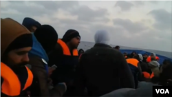 At least half of Syrians say they would like to migrate. Here, young men from Syria record their move out of their country on their mobile phones. 