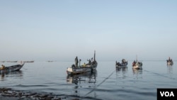 FILE - Fishermen get ready to cast off in the morning off the coast of Joal, Senegal, May 30, 2017. (R. Shryock/VOA)