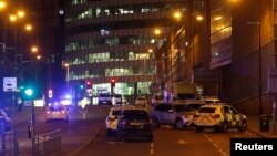 Vehicles are seen near a police cordon outside the Manchester Arena, where U.S. singer Ariana Grande had been performing, in Manchester, northern England, Britain, May 23, 2017. REUTERS/Andrew Yates - RTX373JR