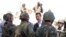 Syria's President Bashar al-Assad, center, chats with military personnel during visit to military site in Daraya,Aug. 1, 2013, SANA handout photo.