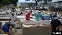 People build burial vaults in the Angela Maria Canalis cemetery as COVID-19 overwhelms sanitary authorities in Guayaquil, Ecuador, April 8, 2020. 