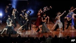Couples dance before the announcement of the winners in the stage category at the World Tango Championship final in Buenos Aires, Argentina, Wednesday, Aug. 23, 2017. (AP Photo/Natacha Pisarenko)