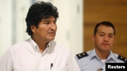 Bolivian President Evo Morales (L) is accompanied by his aide-de-camp at the Vienna International Airport in Schwechat, July 3, 2013. 