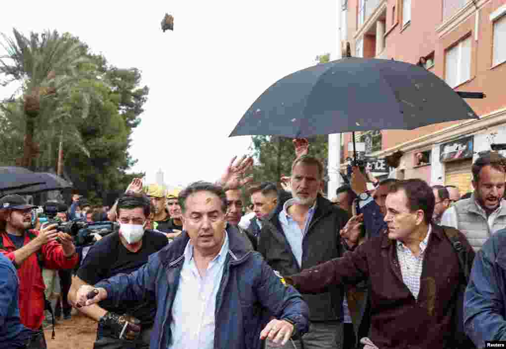 People throw mud at Spain&#39;s King Felipe he visits Paiporta, near Valencia, following heavy rains that caused floods.