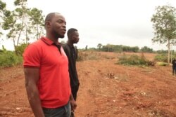 Cocoa farmer David Servor looks at the land that once held his cocoa farm, which was recently destroyed, in Asikesu, Ghana. (S. Knott/VOA)