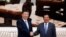 Chinese President Xi Jinping and Cambodian Prime Minister Hun Sen shake hands as they pose for a picture at the Prime Minister's office in Phnom Penh, October 13, 2016.