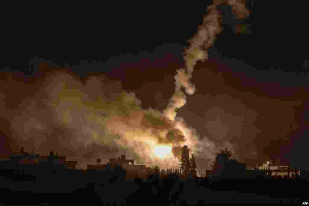 A picture taken from southern Israel along the border with the Gaza Strip shows Israeli army buldozers crossing the border into Gaza, on October 29, 2023 amid ongoing battles between Israel and the Palestinian militant group Hamas. Photo by Menahem KAHAN