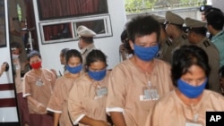 Female suspects allegedly involved in human trafficking of Rohingya migrants file into the Criminal Court in Bangkok, Thailand, Nov. 10, 2015.