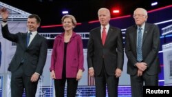 Democratic presidential candidates Pete Buttigieg, Sen. Elizabeth Warren, former Vice President Joe Biden, and Sen. Bernie Sanders pose at the start of the Nov. 20, 2019 debate in Atlanta, Georgia.