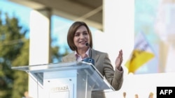 FILE - Moldovan President and candidate to re-election Maia Sandu delivers a speech during a rally to launch her electoral campaign in Chisinau, on Sept. 20, 2024. 