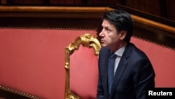 FILE - Italian Prime Minister Giuseppe Conte stands during a session in the Senate, the upper house of parliament, on the spread of coronavirus, in Rome, Italy, March 26, 2020.