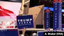 FILE - Delegates wave signs and flags during the Republican National Convention in Cleveland, July 21, 2016.