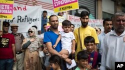 FILE - Afghan refugees in Greece protest, demanding more rights for themselves, in central Athens, Aug. 22, 2017.