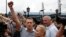 Russian opposition leader Alexei Navalny (L) addresses his supporters after arriving from Kirov, with his wife, Yulia, standing nearby, at a railway station in Moscow, July 20, 2013.