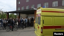 People gather outside a hospital where Russian opposition leader Alexei Navalny receives medical treatment in Omsk, Russia, Aug. 21, 2020. 