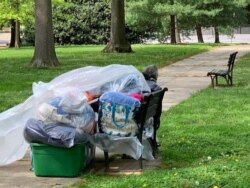 Homeless people live in a Washington, DC, park in tent encampment not far from tourist landmarks and government buildings. (Chris Simkins/VOA)