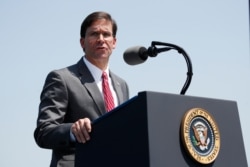 FILE - Secretary of Defense Mark Esper speaks during a full honors welcoming ceremony for him at the Pentagon, July 25, 2019.