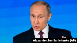 RUSSIA -- Russian President Vladimir Putin gestures as he gives his annual state of the nation address in Moscow, Russia, Thursday, March 1, 2018