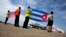 Airport workers receive JetBlue flight 387 holding a United States, and Cuban national flag, on the airport tarmac in Santa Clara, Cuba, Aug. 31, 2016. JetBlue 387 is the first commercial flight between the U.S. and Cuba in more than a half century.