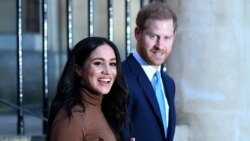 FILE - Britain's Prince Harry, Duke of Sussex and Meghan, Duchess of Sussex react as they leave after her visit to Canada House in London, Jan. 7, 2020.