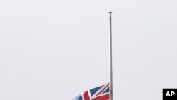 Flag flying at half-mast as mark of mourning and respect in Sydney for three U.S. crew members of an aerial water tanker that crashed while battling wildfires in Australia, Jan. 24, 2020.