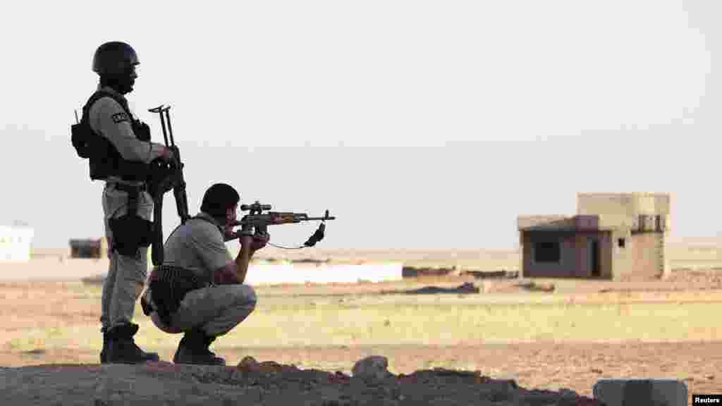 Kurdish Peshmerga troops participate in an intensive security deployment against Islamic State militants in a village on the outskirts of the province of Nineveh near the border province of Dohuk, Iraq, Aug. 9, 2014. 