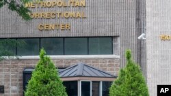An employee checks a visitor outside the Metropolitan Correctional Center, Aug. 13, 2019 in New York. 