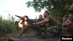 FILE - Members of the Ukrainian armed forces fire a grenade launcher, in response to what servicemen said were shots fired from the positions of fighters of the separatist self-proclaimed Donetsk People's Republic, in the town of Avdiivka, Donetsk region,