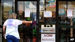 A hiring sign is displayed outside a retail store in Buffalo Grove, Illinois, June 24, 2021. 