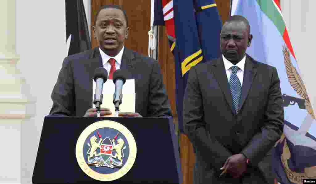 Kenyan President Uhuru Kenyatta, left, with Deputy President William Ruto, addresses a news conference at the State House in Nairobi, Kenya, Dec. 2, 2014.