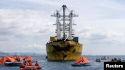 Regu penyelamat melaukan upacara pencarian korban tabrakan kapal feri dan kapal kargo di Talisay, Cebu (17/8). 38 orang dikukuhkan tewas dalam insiden ini, dan 82 orang masih belum ditemukan.