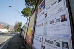 Death notices are seen on a board along an empty road in Alzano Lombardo, near Bergamo, the heart of the hardest-hit province in Italy's region of Lombardy, March 17, 2020.
