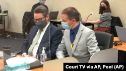 In this image from video, defense attorney Eric Nelson, left, and defendant, former Minneapolis police officer Derek Chauvin listen to Hennepin County Judge Peter Cahill read instructions to the jury before closing arguments, Monday, April 19, 2021. (Court TV via AP, Pool)