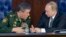 FILE - Russian President Vladimir Putin (r) speaks with Chief of the General Staff of the Russian Armed Forces Valery Gerasimov at a meeting with top military officials in the National Defense Control Center in Moscow, Dec. 11, 2015. 