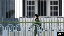 A Chinese paramilitary police officer stands guard outside the Australian embassy in Beijing on Feb. 5, 2024.