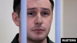 ARHIVA: Bivši američki marinac Trevor Rid iza rešetaka tokom sudskog pretresa u Moskvi, 11. mart 2020.(REUTERS/Tatyana Makeyeva)