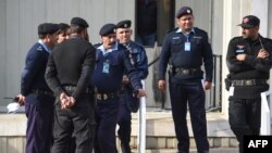 FILE - Pakistani policemen stand guard in front of the Supreme Court building during the court review appeal against a Pakistani Christian woman who spent eight years on death row for blasphemy, in Islamabad on Jan. 29, 2019.