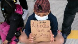 Migrants and asylum seekers demonstrate at the San Ysidro crossing port asking US authorities to allow them to start their migration process in Tijuana, Baja California state, Mexico on March 23, 2021.
